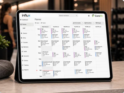 The InfluxClub planner open on a tablet at a gym reception desk